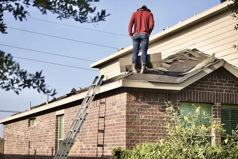 Professional roofer working on a residential roof in Harwood Park